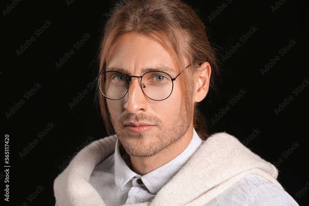 Handsome man with stylish hairdo on dark background Handsome man with stylish hairdo on dark background
