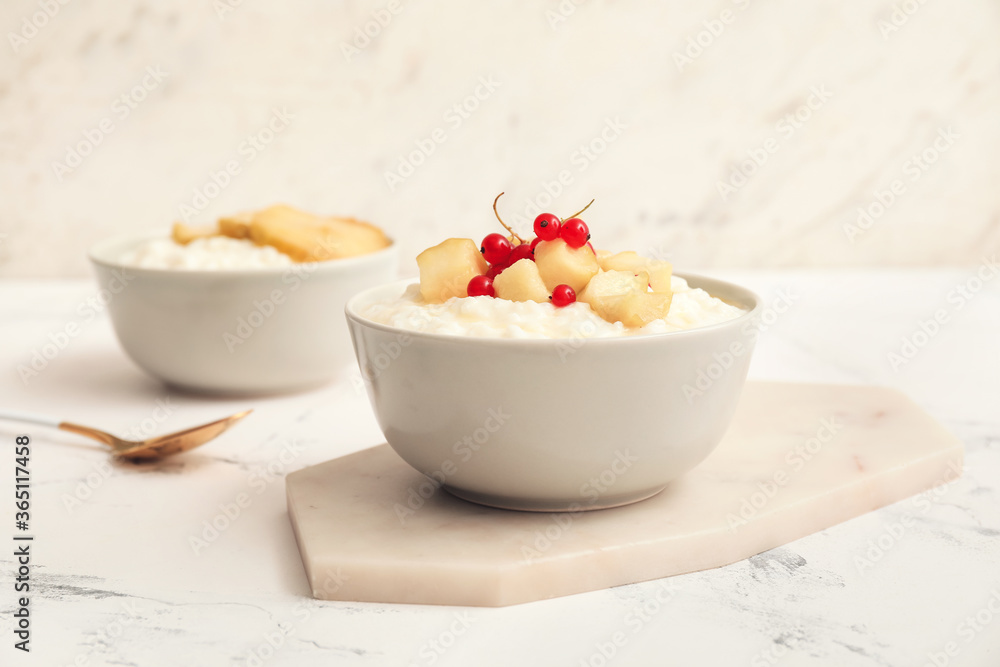 Bowl with boiled rice and fruits on table Bowl with boiled rice and fruits on table
