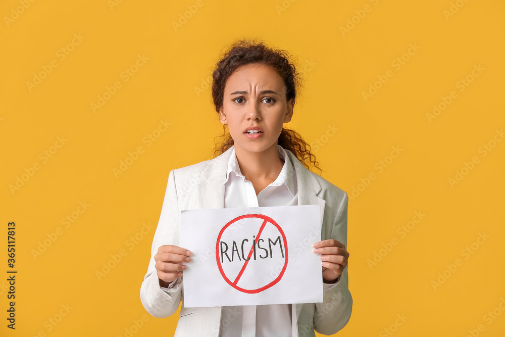 African-American woman with poster on color background. Stop racism African-American woman with poster on color background. Stop racism