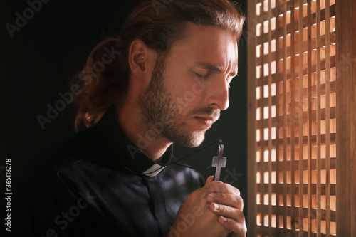 Male priest in confession b...