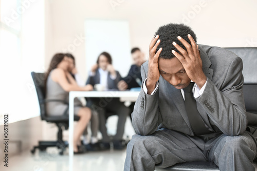 Foto Lonely African-American businessman in office. Stop racism