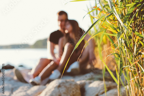 Couple sitting on stones near the sea
