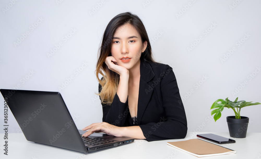 A young Asian businessman is working in the office and he also works freelance online through SEM. A young Asian businessman is working in the office and he also works freelance online through SEM.