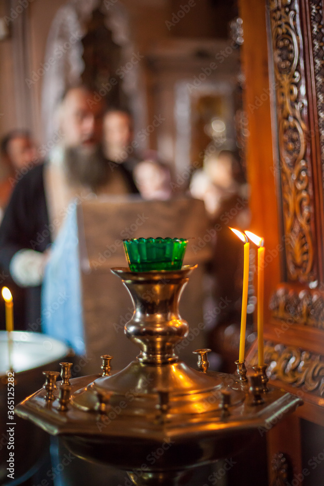 A candle burns in the temple. Interior of the Christian Church.