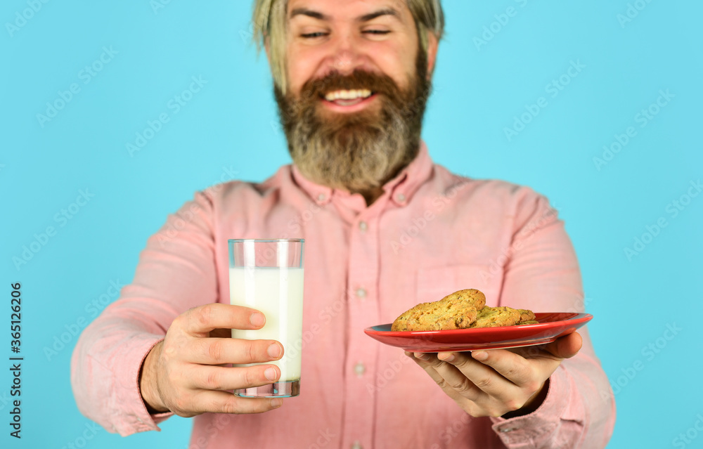 man love bakery. bakery goods concept. his favorite food. enjoying freshly baked pastries. happy farmer eat dessert. bearded man drink useful milk with pastry. cookie and glass of milk