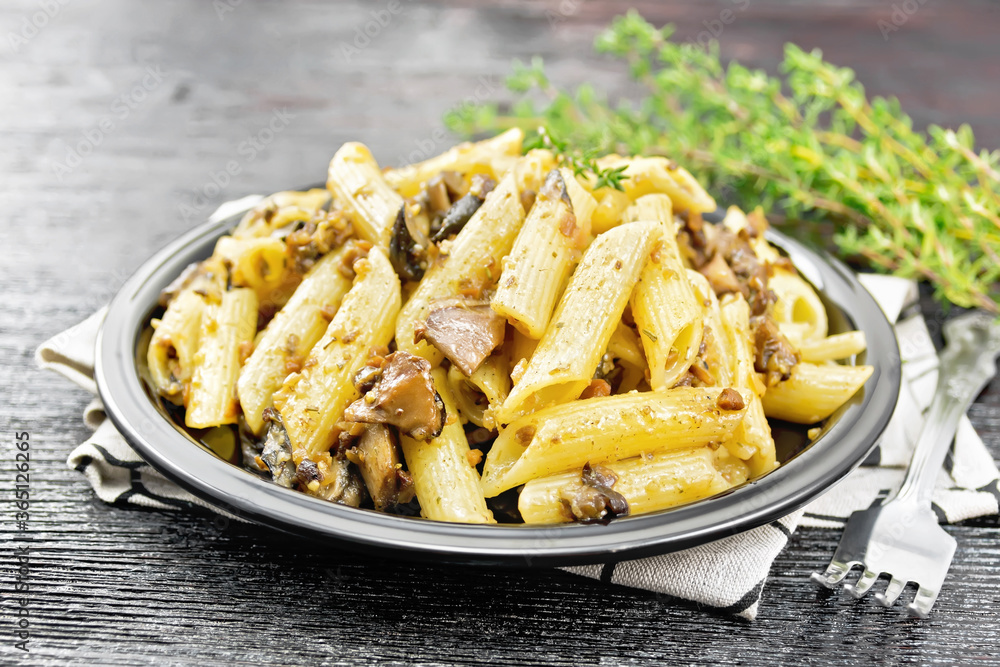 Pasta with mushrooms in plate on black board Pasta with mushrooms in plate on black board