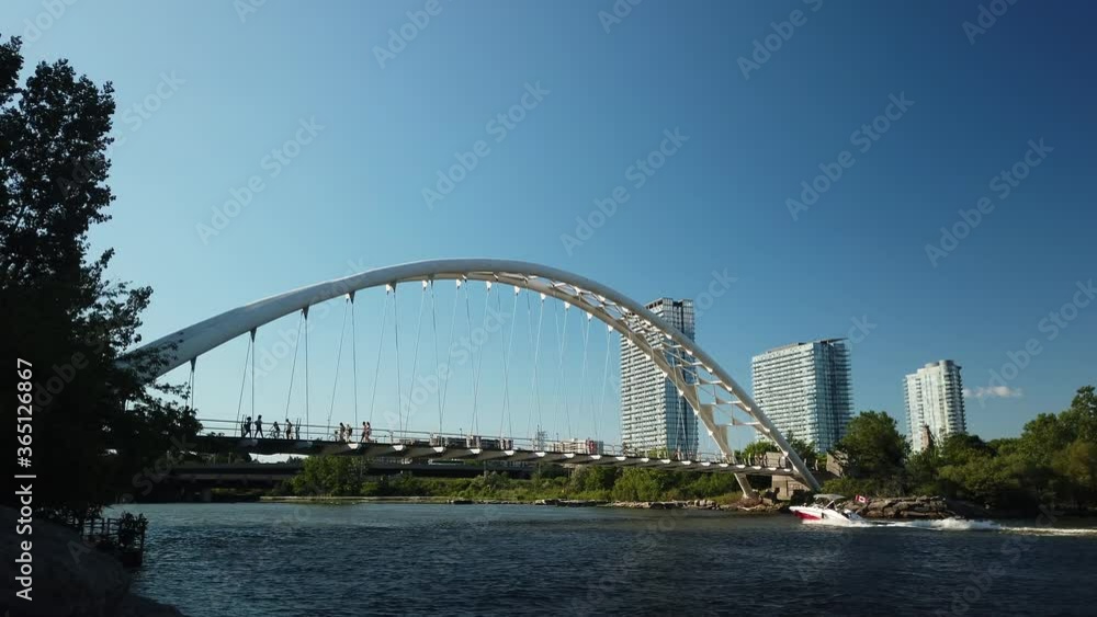 Wide shot of pedestrian and boat traffic around the Humber Bay Arch Bridge on Canada Day Wide shot of pedestrian and boat traffic around the Humber Bay Arch Bridge on Canada Day