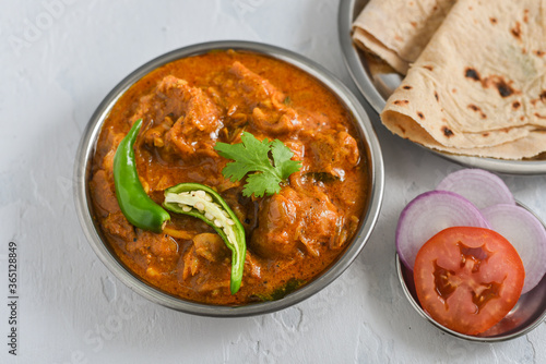 Murghi ka Saalan chicken curry with gravy and roti, hot and spicy dish in Pakistan. Traditional chicken curry Pakistani side dish masala chicken served with Chapati, rice, naan, Paratha, Parantha.