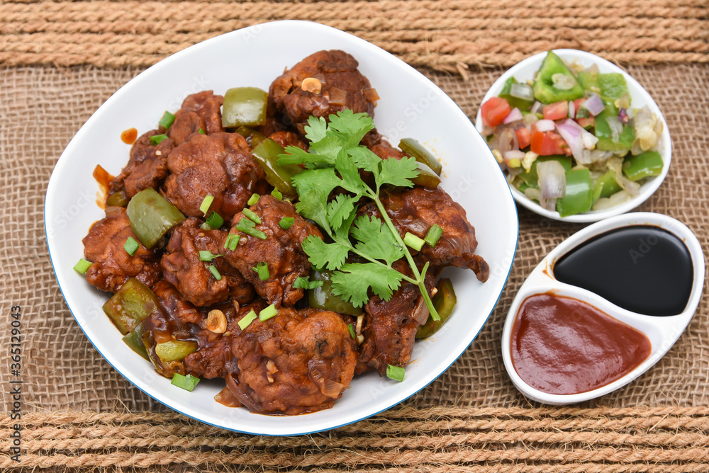 Chicken manchurian, sweet chilli chicken, red hot and spicy curry Mumbai, Delhi India. Popular North Indian side dish for chapati, roti, naan, paratha, fried rice, pulao. Indo Chinese cuisine. Chicken manchurian, sweet chilli chicken, red hot and spicy curry Mumbai, Delhi India. Popular North Indian side dish for chapati, roti, naan, paratha, fried rice, pulao. Indo Chinese cuisine.