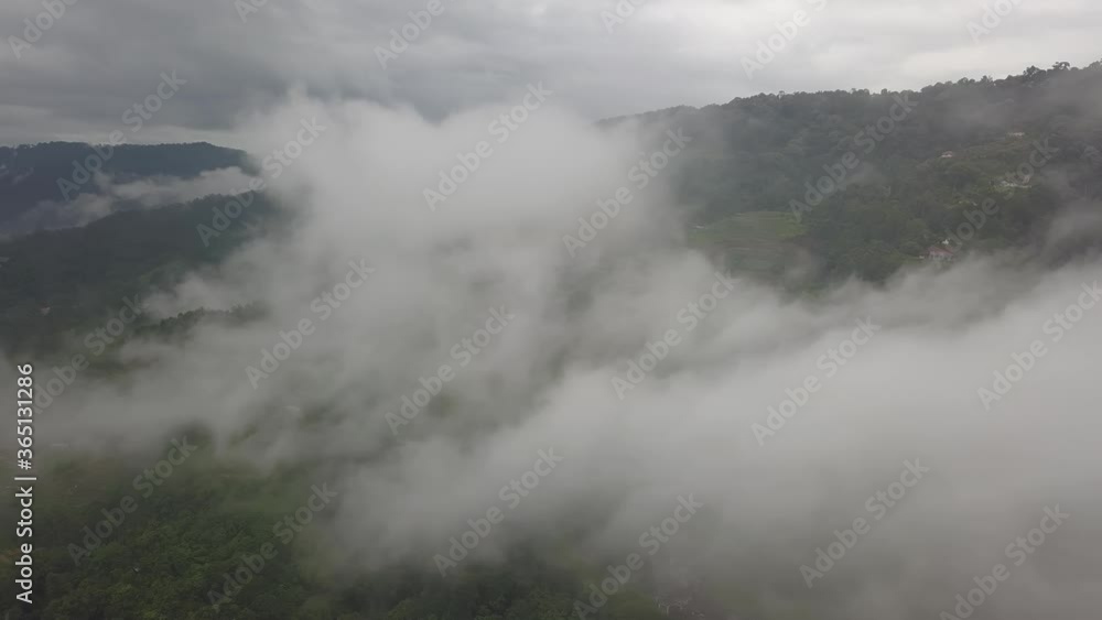 Aerial view over cloud at green forest of Penang Hill.