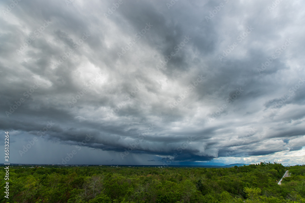 Storm clouds with rain over meadow with forest Storm clouds with rain over meadow with forest