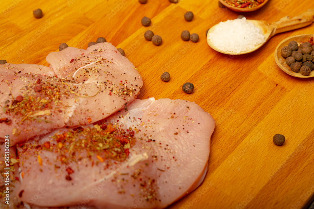 Meat steaks and various spices on a wooden Board. Close up. Meat steaks and various spices on a wooden Board. Close up.
