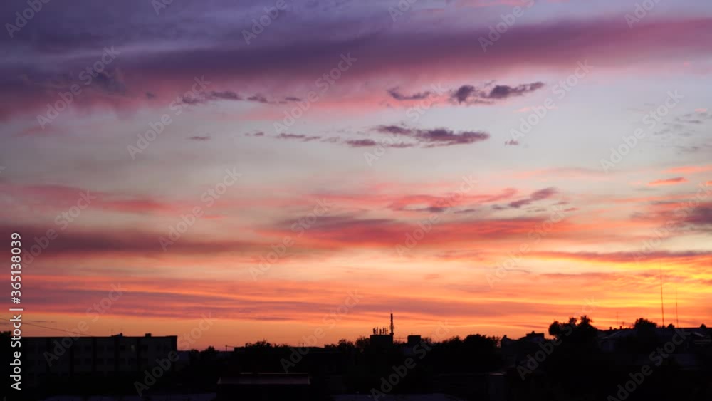 Beautiful evening blue sky at sunset with flaming bright light clouds. A warm summer evening at sunset. Bright sunset. Beautiful evening blue sky at sunset with flaming bright light clouds. A warm summer evening at sunset. Bright sunset.