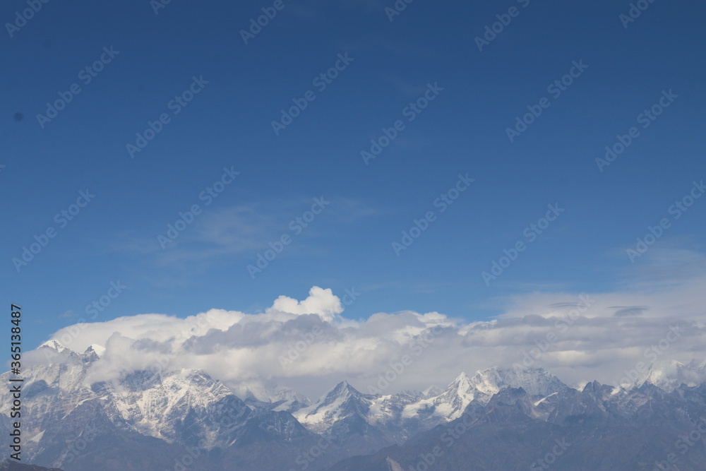 snow covered mountains clouds and sky
snow covered mountains clouds and sky
