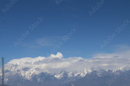 snow covered mountains clouds and sky  © Sudip