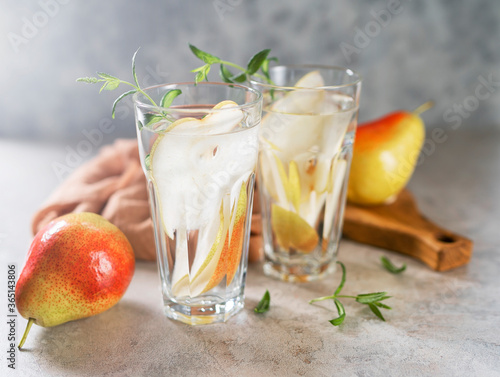 Cool summer drinks, pear cocktails with ice in glasses. photo