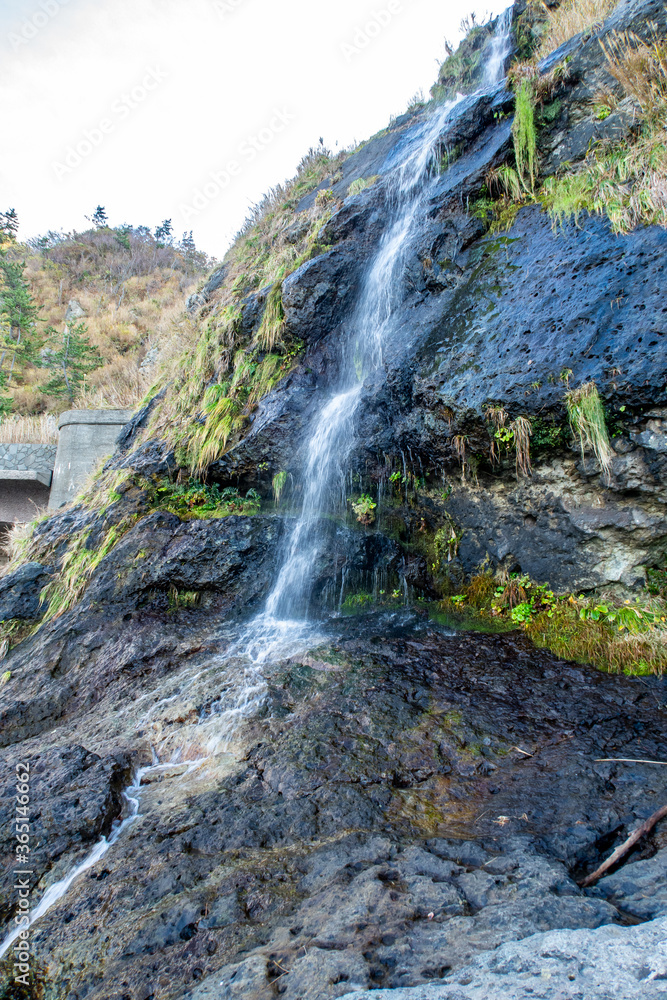 Obraz premium Tarumi Waterfall located between Wajima and Suzu cities, close to Seppun tunnel, falling from 30m cliff to the Sea of Japan on the Sosogi coast of Noto Peninsula, Japan