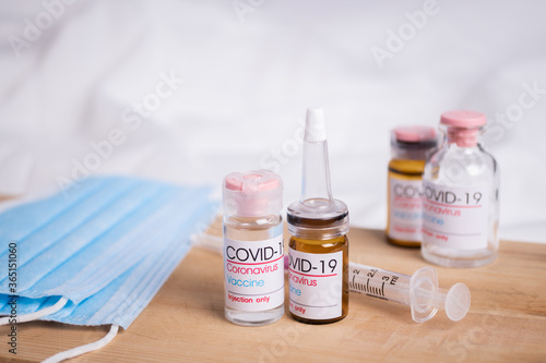 Bottle of coronavirus vaccine on table. Coronavirus vaccine COVID-19.