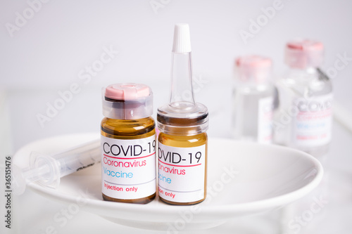 Bottle of coronavirus vaccine on table. Coronavirus vaccine COVID-19.