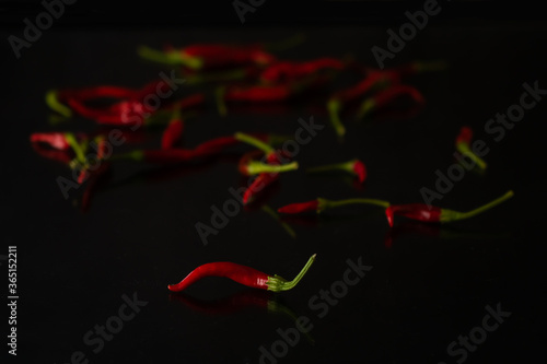 Red hot chilly pepper on black table top