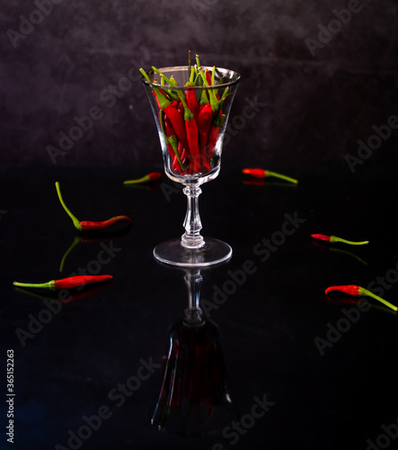Red hot chili pepper in old wine glass