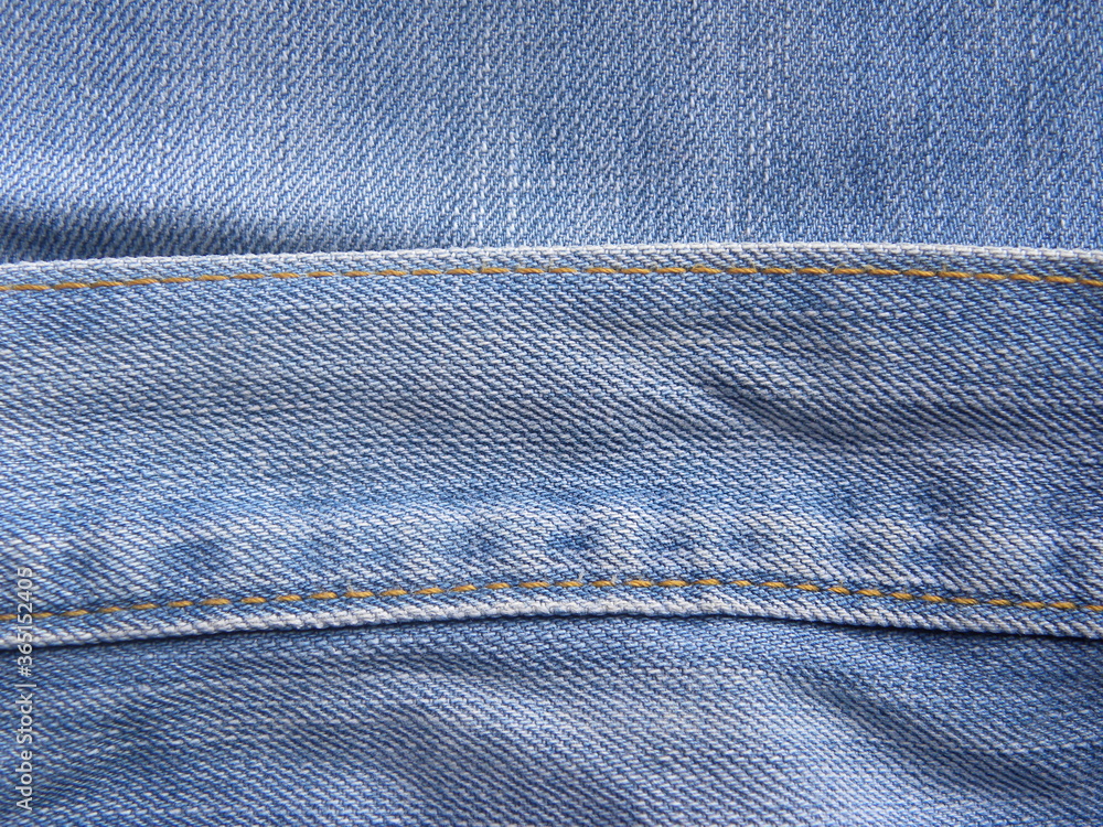 Bound seam of waist band of light blue color jeans Bound seam of waist band of light blue color jeans