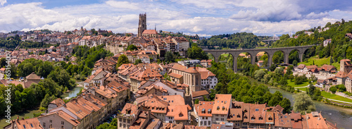 Aerial views of the rooftops, landmarks, river and bridges of the old town of Fribourg in Switzerland.