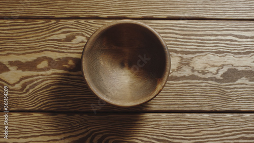 TOP VIEW: Empty wooden cup on a wooden table
