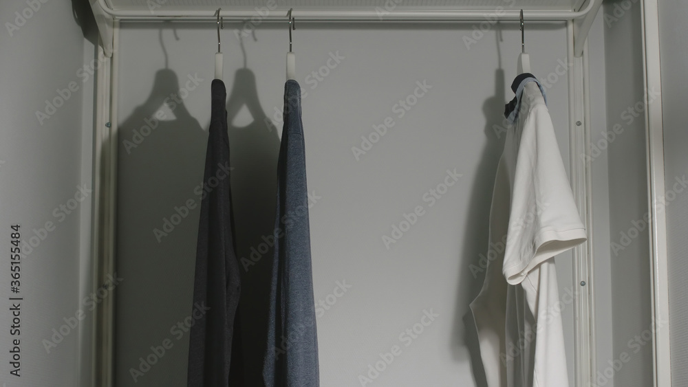 Several Male's clothes in a wardrobe at home