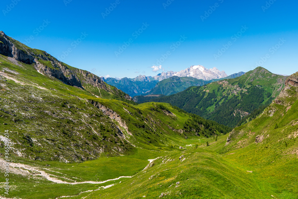beautiful valleys in the dolomites and in the background marmolada