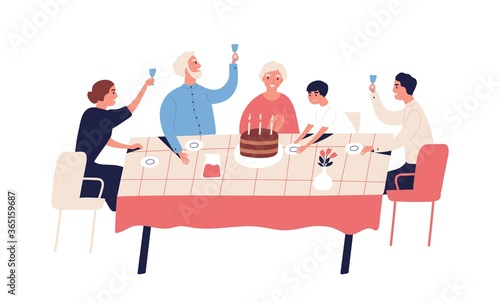 Family celebration of grandparents birthday. People sitting at table with cak...