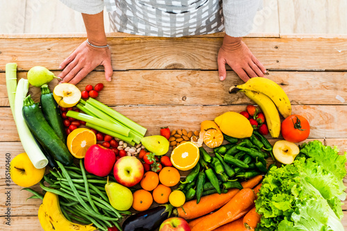 Table view of coloured mix of fresh and seasonal fruits and vegetables for vegan or vegetarian or just heathy food - diet and weight loss ingredieents - housewife chef ready to cook at home