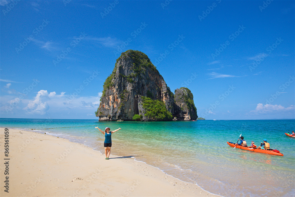 Obraz premium photo taken on a wide angle lens, girl on the shore of the azure sea in Thailand, the transparent sea, a picturesque island, paradise pleasure, travel and vacation