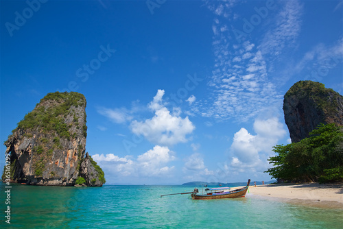 photo taken on a wide angle lens, thai fishing boats on the azure sea on the bounty beach in thailand, clear sea, picturesque island, paradise enjoyment, travel and vacation, background for postcards