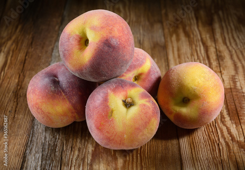 ripe peaches close-up on a dark wooden rustic background, horizontal view