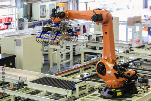 Factory 4.0 concept. Industrial robot in smart warehouse system for manufacture factory