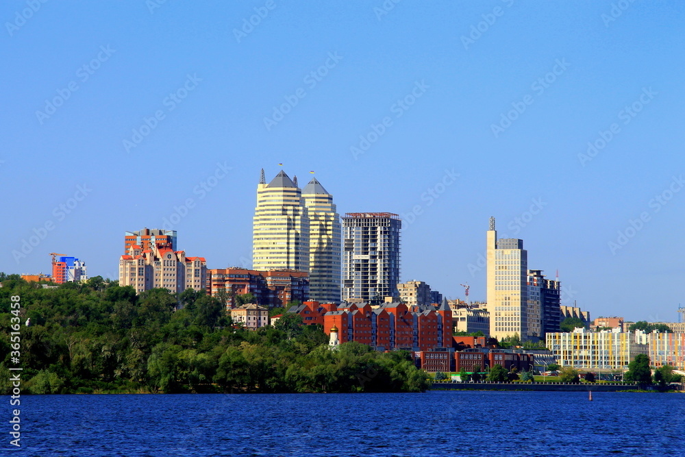 Sunny summer, spring morning on the Dnieper river, view of the Monastery Island, buildings and white skyscrapers of Dnipro city, landscape. Dnepropetrovsk, Ukraine Sunny summer, spring morning on the Dnieper river, view of the Monastery Island, buildings and white skyscrapers of Dnipro city, landscape. Dnepropetrovsk, Ukraine