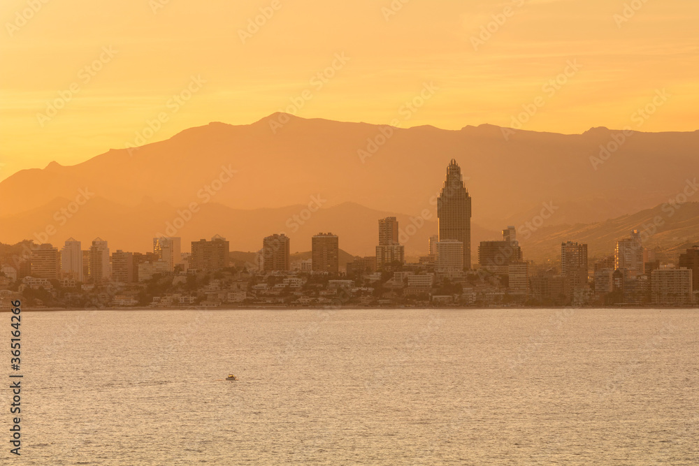 Golden silhouettes of Benidorm city at the sunset, Alicante, Spain