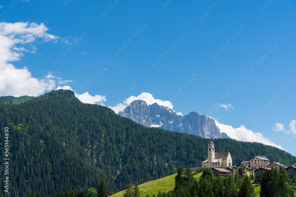 Ancient church dedicated to Saint Lucy in Colle Santa Lucia, with a breathtaking view over the Civetta mountain, Dolomites (IT)