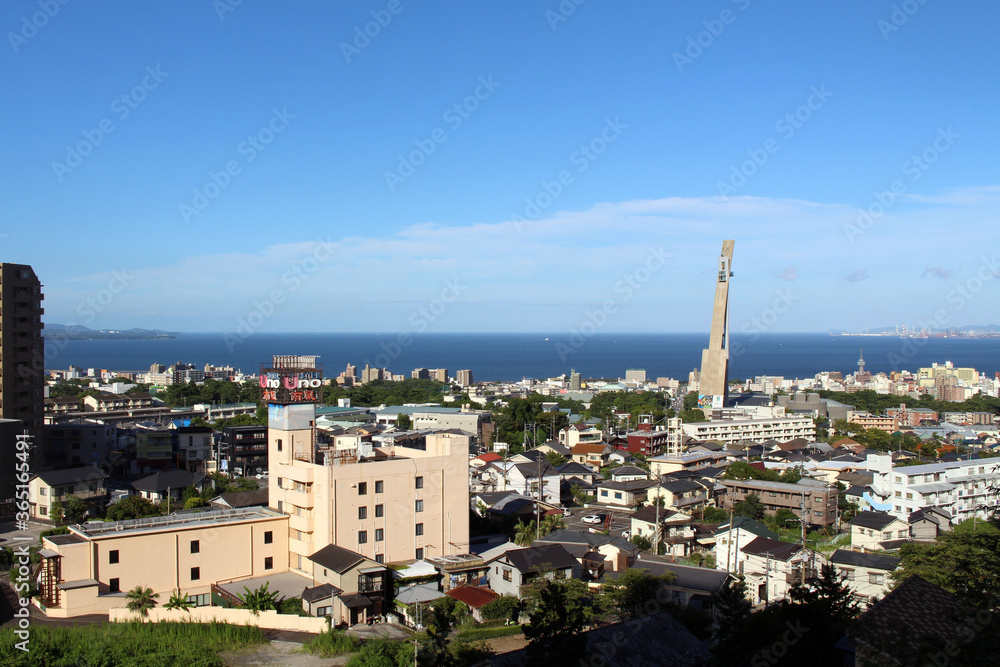 The panoramic view of Beppu City, its Tower, and the sea in Oita Prefecture, Japan
