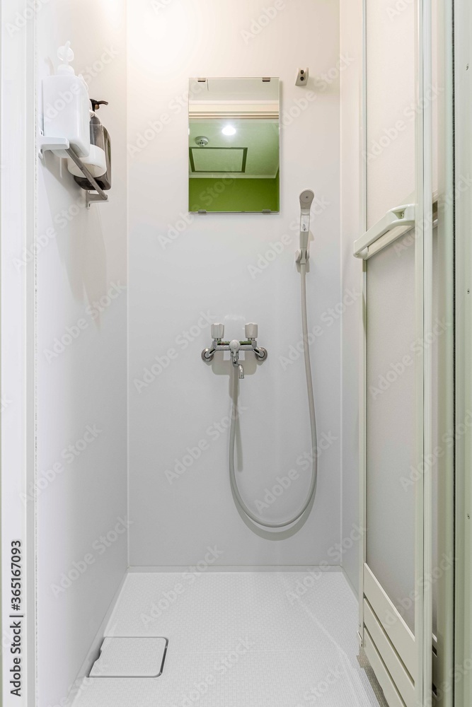 Obraz premium Empty corner rounded shower cabin with closed sliding glass door