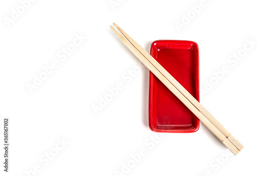 Top view of red bowl chopsticks on white background