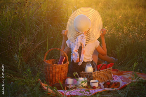 Little girl in a hat on a picnic
