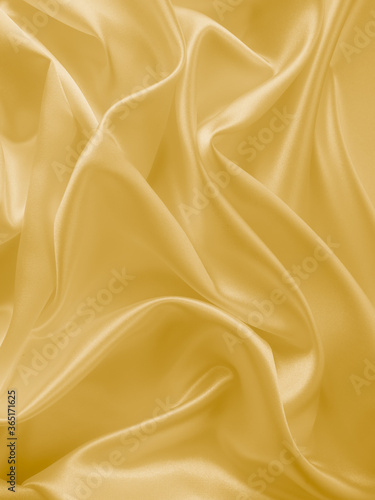 Beautiful smooth elegant wavy light yellow satin silk luxury cloth fabric texture, abstract background design. Copy space. Wedding, engagement concept.