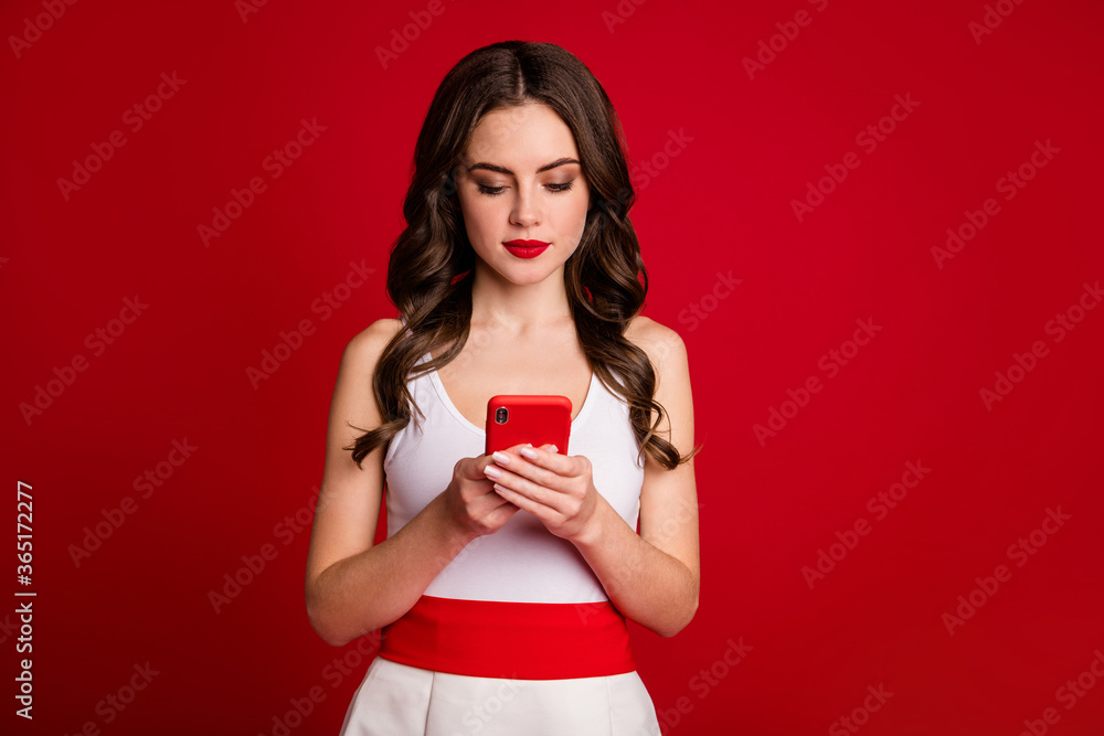 Photo of pretty charming lady millennial hold telephone hands chatting friends read message email typing answer wear white dress isolated bright red color background Photo of pretty charming lady millennial hold telephone hands chatting friends read message email typing answer wear white dress isolated bright red color background
