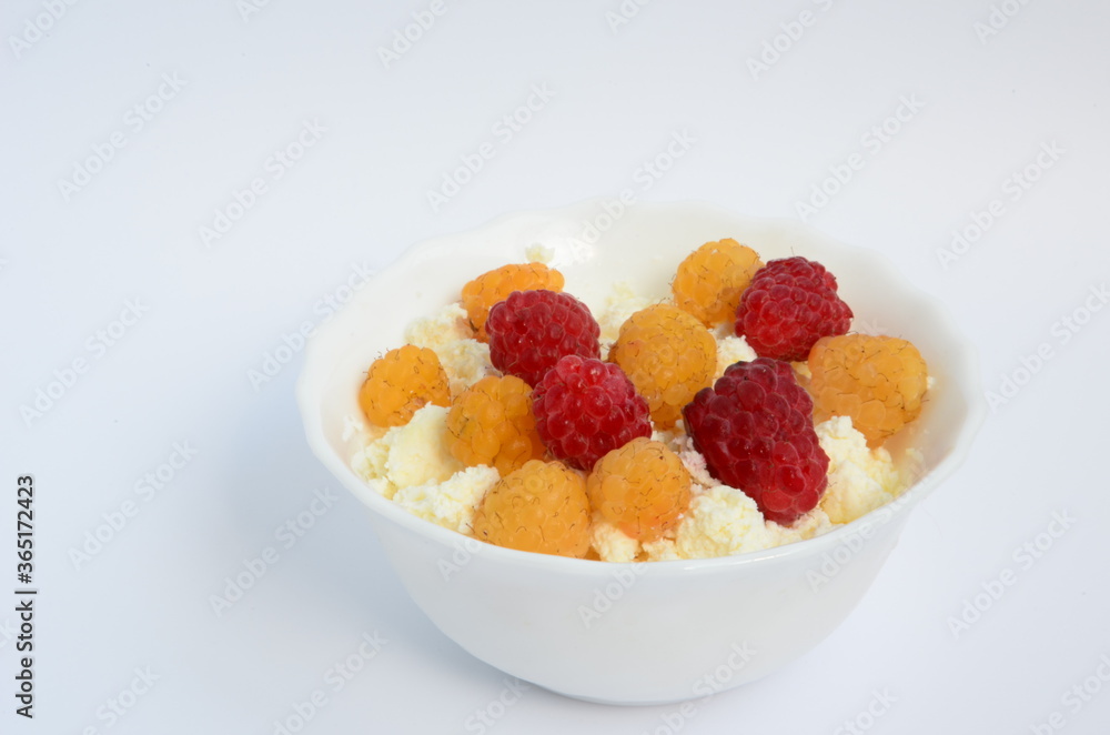 Homemade red and yellow raspberry cheese in a white plate
