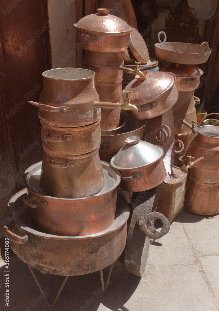 Copper pots and kitchenware at a market in Fes in Morocco Copper pots and kitchenware at a market in Fes in Morocco