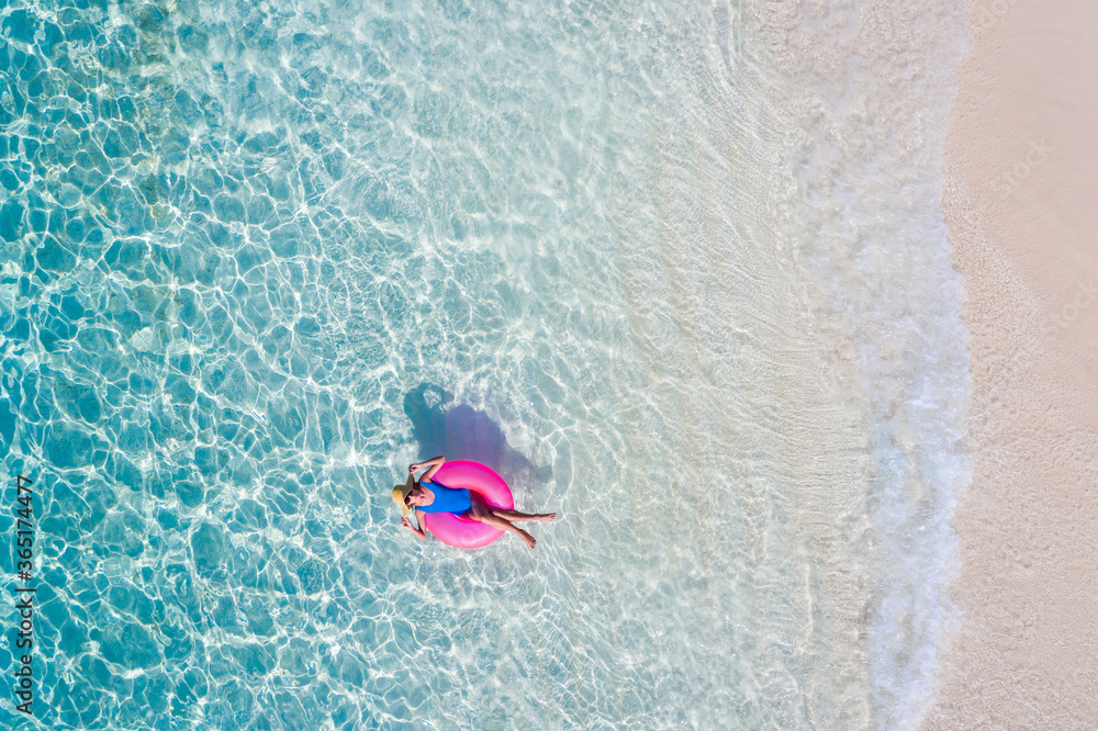 Top above high angle aerial drone view of her she attractive girl floating on rubber ring in transparent ocean water coastline sunny weather spending season luxury place summertime daydream - obrazy, fototapety, plakaty 