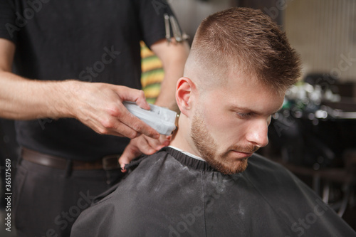 Male client getting new haircut at the barbershop