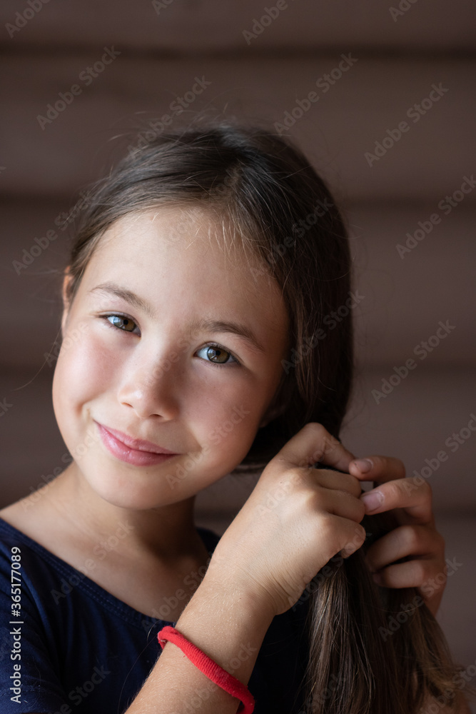 Portrait of a young girl braiding a braid in vintage style Portrait of a young girl braiding a braid in vintage style